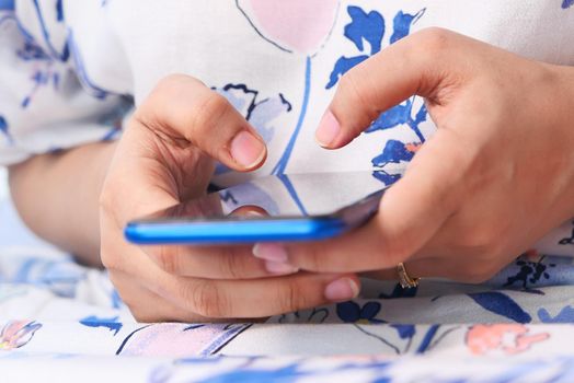 close up of women hand holding smart phone.