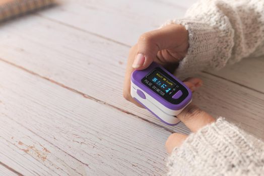 young women hand using pulse oximeter.