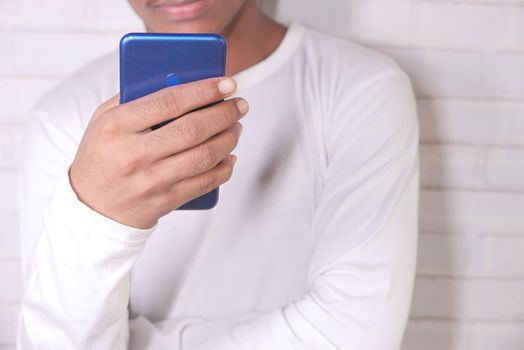 young man in casual dress using smart phone..