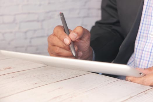 businessman using digital tablet on office desk .