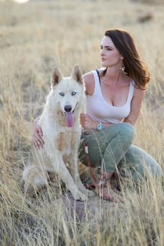 Out and about. an attractive young woman bonding with her dog outdoors