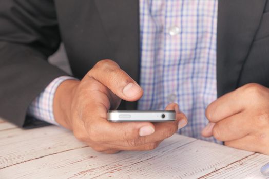 Close up of young man hand using smart phone
