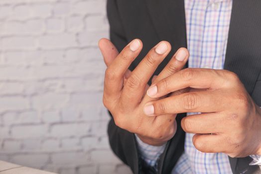 man suffering pain in hand close up .