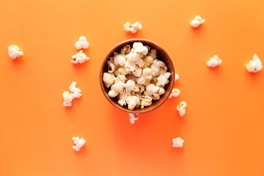 popcorn in a bowl on orange background ,