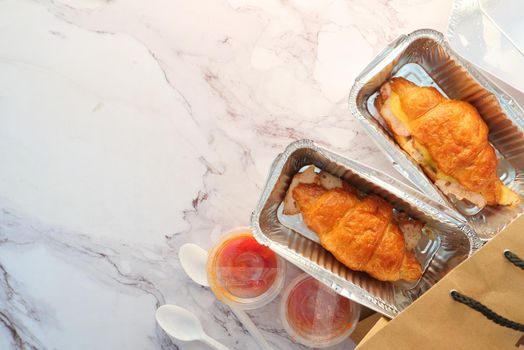 sub sandwich in a take away containers, top view