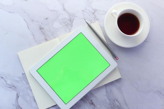 Flat composition of digital tablet and office stationary on tiles background .