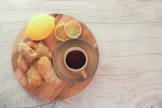 Top view of ginger tea on wooden background..