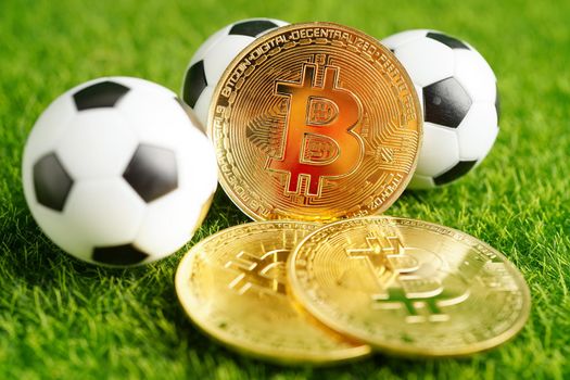 Gold bitcoin with soccer ball or football, cryptocurrency used in online sports betting.