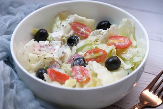 Close up of greek salad in a bowl on table