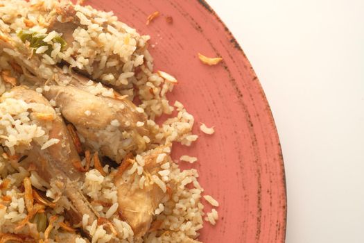 chicken biryani meal in a bowl on table