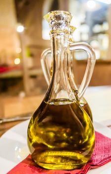 Natural food, Mediterranean diet and healthy eating concept - Bottles of organic extra virgin olive oil in Italian restaurant