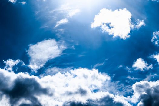 Nature backdrop, solar energy and spiritual concept - Blue sky background, white clouds and bright sunlight