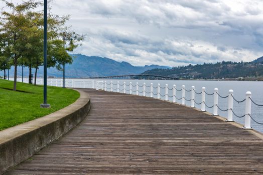 Wooden boardwalk along the waterfront on Okanagan lake in British Columbia.