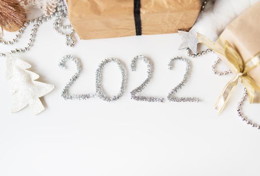 Happy New Year 2022. Festive decor - Christmas tree, gift, star, tinsel. Blank copy space for decal or other objects