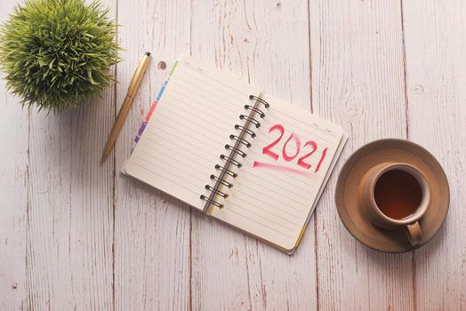 top view of new year goals text on notepad