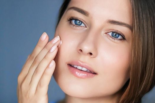 Beauty, skincare and cosmetic product, woman applying anti-aging face cream on her skin, portrait