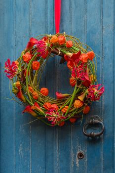 Wreath of autumn plants with physalis and orchids