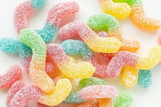 Colorful tasty jelly candies on a white background, top view