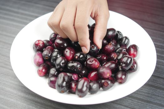 top view of black plum on a plate