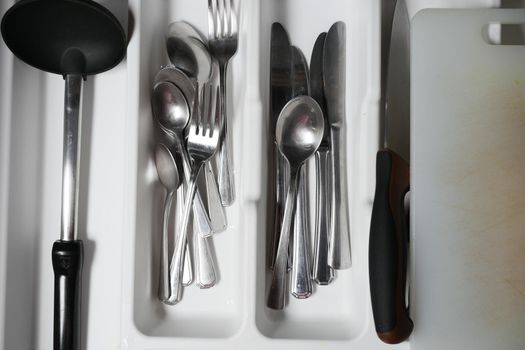 fork, knife and spoon on in a drawer top view ,