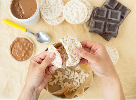 Top view of the process of preparing a delicious dessert peanut butter along with rice cakes. Vegan dessert, tasty and healthy