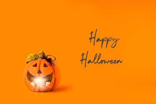 Happy halloween text. Holiday concept. Jack o lantern decorations with lights bokeh, spider on orange background. Halloween festival party, greeting card mockup with copy space.