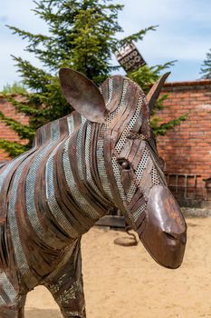 Stare Mesto, Czech Republic 29 April 2022 KOVOZOO original exposition of metal waste, technology and retro objects. Zebra head, made of scrap metal