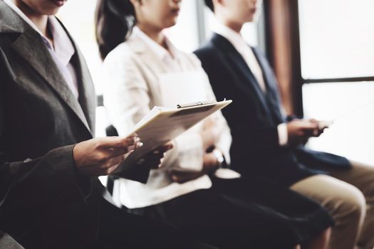 Graduate students holding resume are waiting for an interview to work with the company.