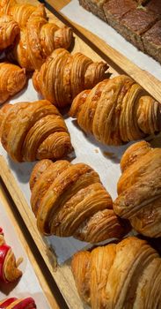 Close up group of fresh baked delicious croissants, super delicious warm fresh buttery Croissants and Rolls, French and American Croissants and baked pastries are enjoyed world wide on bakery shop, tasty multiple croissant