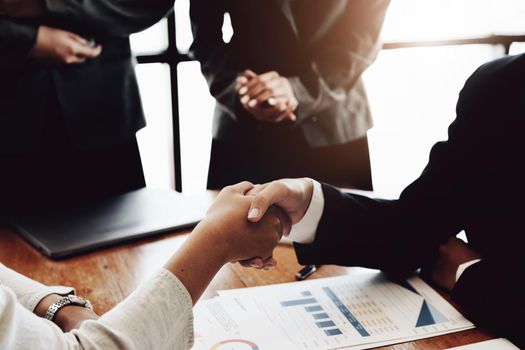 The handshake symbolizes, Group of entrepreneurs showing signs of merger to enhance their competitiveness in marketing, together concept