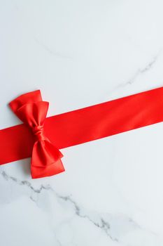 Holiday decor, feminine design and flatlay concept - Red silk ribbon on marble, top view