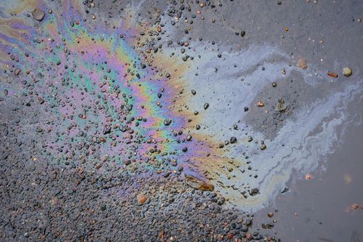 Oil slick on the asphalt road background