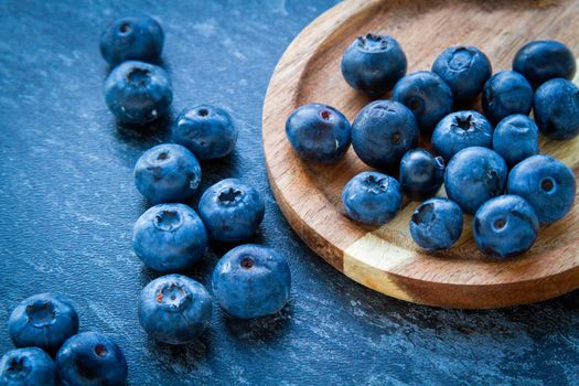 Blueberries on a wooden table. Fresh berries. Wild blueberries on a wooden stand. Copyspace.