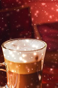 Hot drink, New Years Eve and Valentines Day celebration concept - Winter holiday latte coffee glass and glowing snow in a restaurant, Christmas time menu recipe