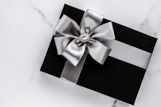 Present for him, shop sale promotion and anniversary celebration concept - Luxury holiday gifts with silver silk ribbon and bow on marble background