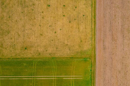 Aerial view of agricultural fields with patterns of lines and tracks