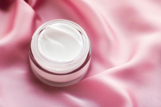 Beauty, anti-age cosmetics and skincare concept - Luxury face cream jar on a soft pink silk