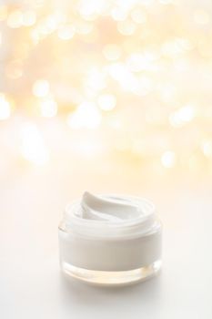 Beauty, anti-age cosmetics and skincare concept - Luxury face cream jar and holiday glitter