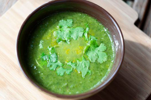 Fresh healthy spinach green soup on wooden background overhead shoot.High quality photo