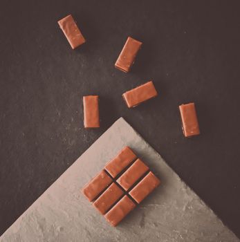 Sweet swiss chocolate candies on a stone tabletop, flatlay - desserts, confectionery and gluten-free organic food concept. All you need is chocolate