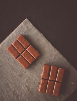 Sweet swiss chocolate candies on a stone tabletop, flatlay - desserts, confectionery and gluten-free organic food concept. All you need is chocolate