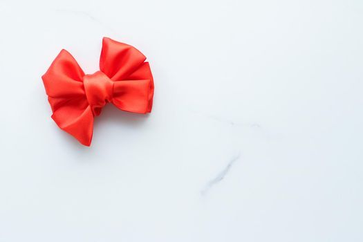 Holiday decor, feminine design and flatlay concept - Red silk ribbon on marble, top view