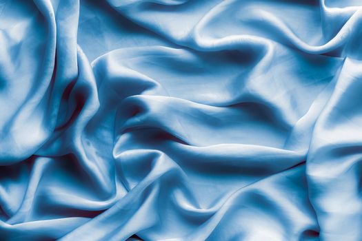 Blue soft silk waves, flatlay - elegant fabric textures, abstract backgrounds and modern pastel colours concept. Feel the touch of luxury