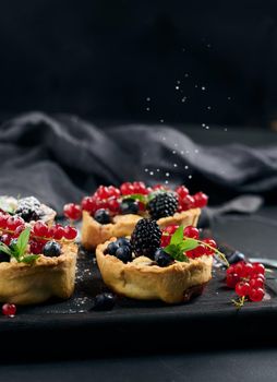 Ripe red cherries in a plate on a white table, close up