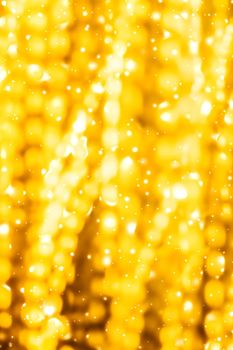 Golden Christmas lights, New Years Eve fireworks and abstract texture concept - Glamorous gold shiny glow and glitter, luxury holiday background