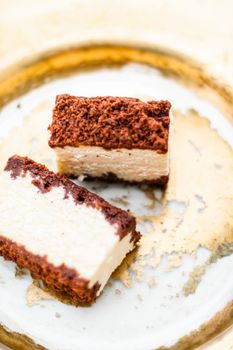 Sweet food, restaurant and luxury gourmet gastronomy concept - Classic cheesecake with chocolate on a golden plate, european cuisine dessert