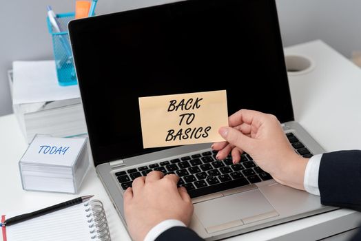 Sign displaying Back To Basics, Word Written on Return simple things Fundamental Essential Primary basis Lady in suit holding pen symbolizing successful teamwork accomplishments.