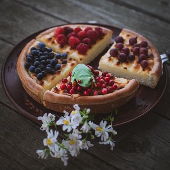 Red-eyed tree frog Homemade cheesecake Pie with berries On Wooden Background