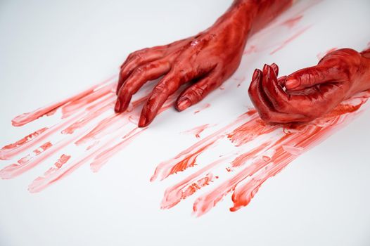 Female hands in blood on a white background