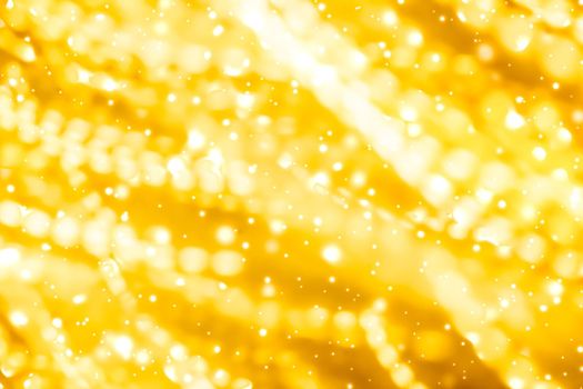 Golden Christmas lights, New Years Eve fireworks and abstract texture concept - Glamorous gold shiny glow and glitter, luxury holiday background